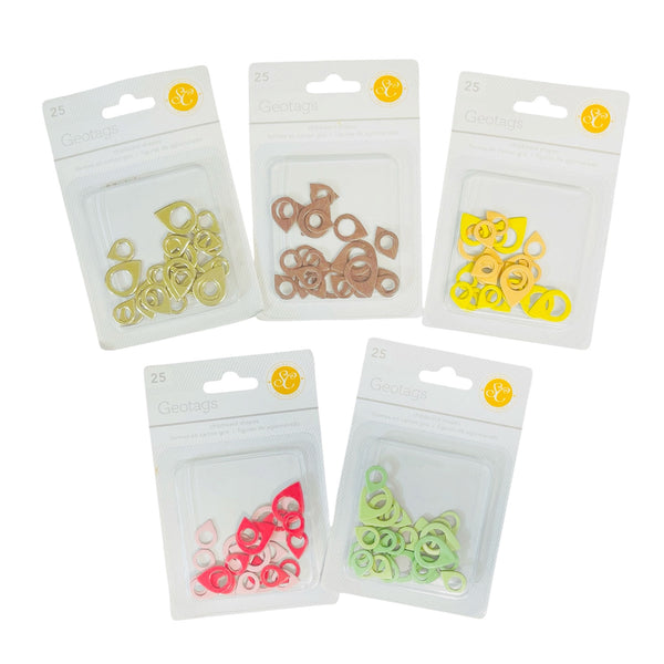 Five clear plastic blister packs containing small colorful ring-shaped geode charms, arranged on a white background. The charms come in yellow, tan, orange-yellow, pink, and light green.
