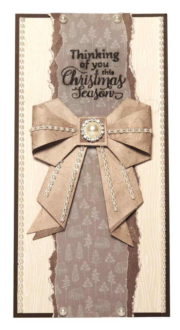 Card with decorative bow and text 'Thinking of you this Christmas Season' on a textured background