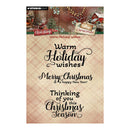Studio Light Clear Stamp holiday greeting card design with multiple Christmas-themed text stamps including 'Warm Holiday wishes', 'Merry Christmas & a happy New Year!', and 'Thinking of you this Christmas Season' on a beige plaid background.