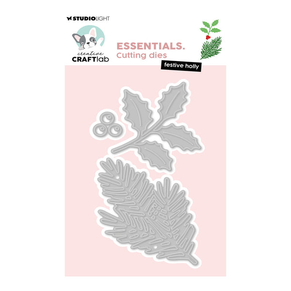 A product packaging shot for 'Festive Holly' cutting dies by Studio Light and Craftlab. The image shows a light gray metal die set shaped with holly leaves and pine branches, presented on a pale pink card against a white background with brand logos at the top.