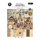 A die-cut designer paper pad titled 'Warm Winter' by Butterfly Studio and Essentials for All, featuring a collage of cozy winter illustrations including a cabin, fireplace, snow, stockings, and patterned paper swatches.