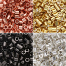 A 2x2 collage showing small metallic cylindrical beads or spacers in four color options: copper/rose-gold, gold, black, and silver, each panel filled with the beads on a plain background.