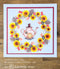 Card with a teapot design surrounded by sunflowers and leaves on a wooden surface