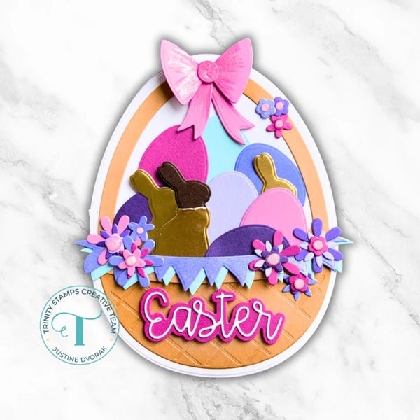 Colorful Easter egg-shaped card with bunnies, flowers, and a pink bow on a marble background.