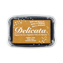 A Delicata Pigment Ink pad in 'Golden Glitz' inside a clear plastic clamshell container.