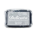 A square Delicata pigment ink pad in a clear plastic clamshell container.