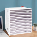 White paper organizer on a desk with a blue wall background