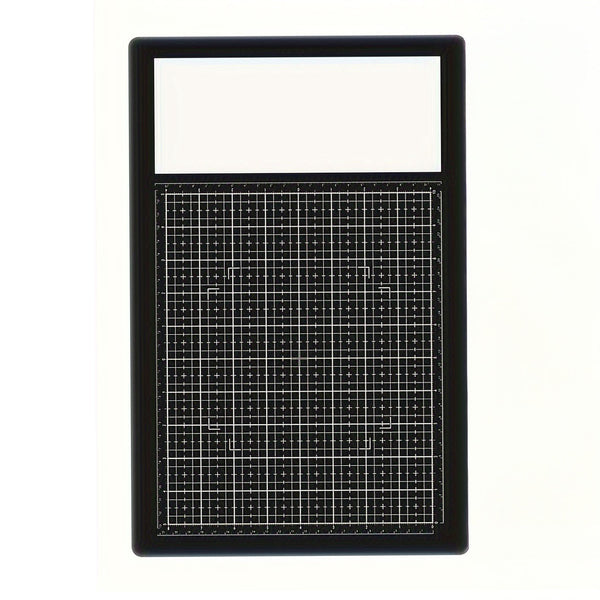 A black rectangular grid mat with a white top section, photographed against a plain white background.