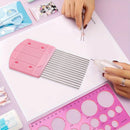 Pink comb, ruler, and scissors on a pink surface with hands using them.