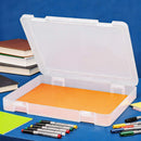 Clear plastic storage box with orange interior on a blue background with markers and books.