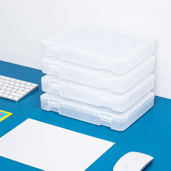 Stack of clear plastic storage boxes on a blue surface with office supplies.