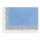 A square decorative print or card featuring a winter holiday design with a light blue snow-filled sky, white snowflakes, blue and white floral garlands along the border, and a white wood-plank patterned lower section with scattered silver snowflakes.