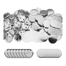 Collection of silver buttons and badge blanks on a white background