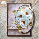 A handmade greeting card featuring a 3D floral design with pale blue and white flowers, green leaves, and a banner that reads 'Life is better with flowers'. The card is displayed on a rustic wood background, with an 'Elizabeth craft designs' logo in the top-left corner.