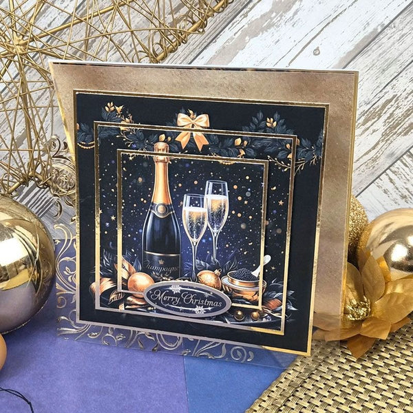A square Christmas greeting card with a gold border and festive illustration of a champagne bottle, two champagne flutes, ornaments, and a 'Merry Christmas' banner on a dark navy background, styled with gold and blue holiday decorations.