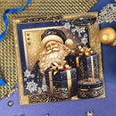 A square Christmas greeting card featuring Santa Claus with wrapped presents, surrounded by gold and navy decorative borders and holiday ornaments, photographed on a blue surface with ribbon and gold accents.