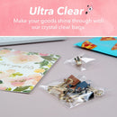 Clear plastic bags packaging gold paper clips on a pink background with text 'Ultra Clear'.